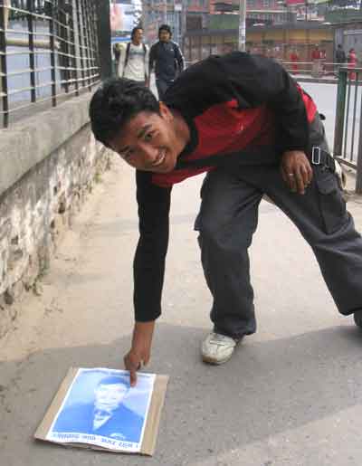 A boy tired to pic up a placard, with photo of Umesh Chandra Thapa who was killed in Dang by army on the election day