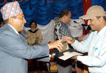 J Pandey, a Nepaljung-based reporter, receiving the award from Chairman Hem Raj Gyawali