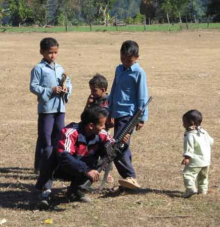 Maoist guerilla playing with gun and child