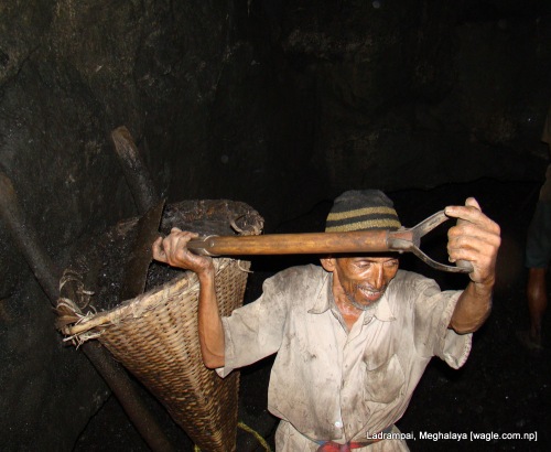 Ladrampai, Meghalaya mine labourer from nepal Shaym Prasad Pokharel fills up the basket with coal
