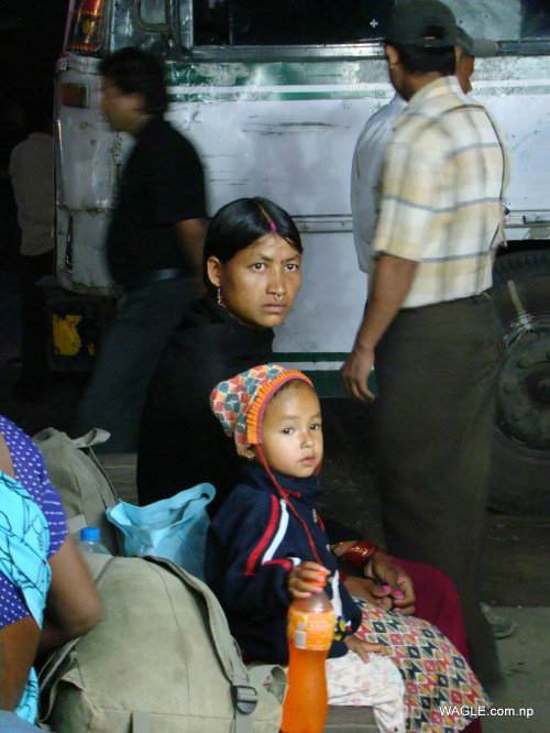 A kid and his mother: India bound- expecting to a earn living that Nepal, their country, couldn't provide. At the bus stand in Banbasa, Indian town bordering far west Nepal