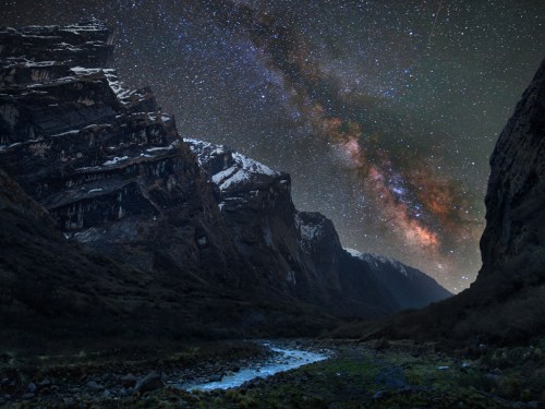 The Milky Way as seen in the Mardi Khola valley in the Himalayas, with clouds of galactic dust illuminated in red by young stars. Anton Jankovoy braved freezing temperatures for this shot during a trek in Nepal Photograph: Anton Jankovoy/ Caters News Agency